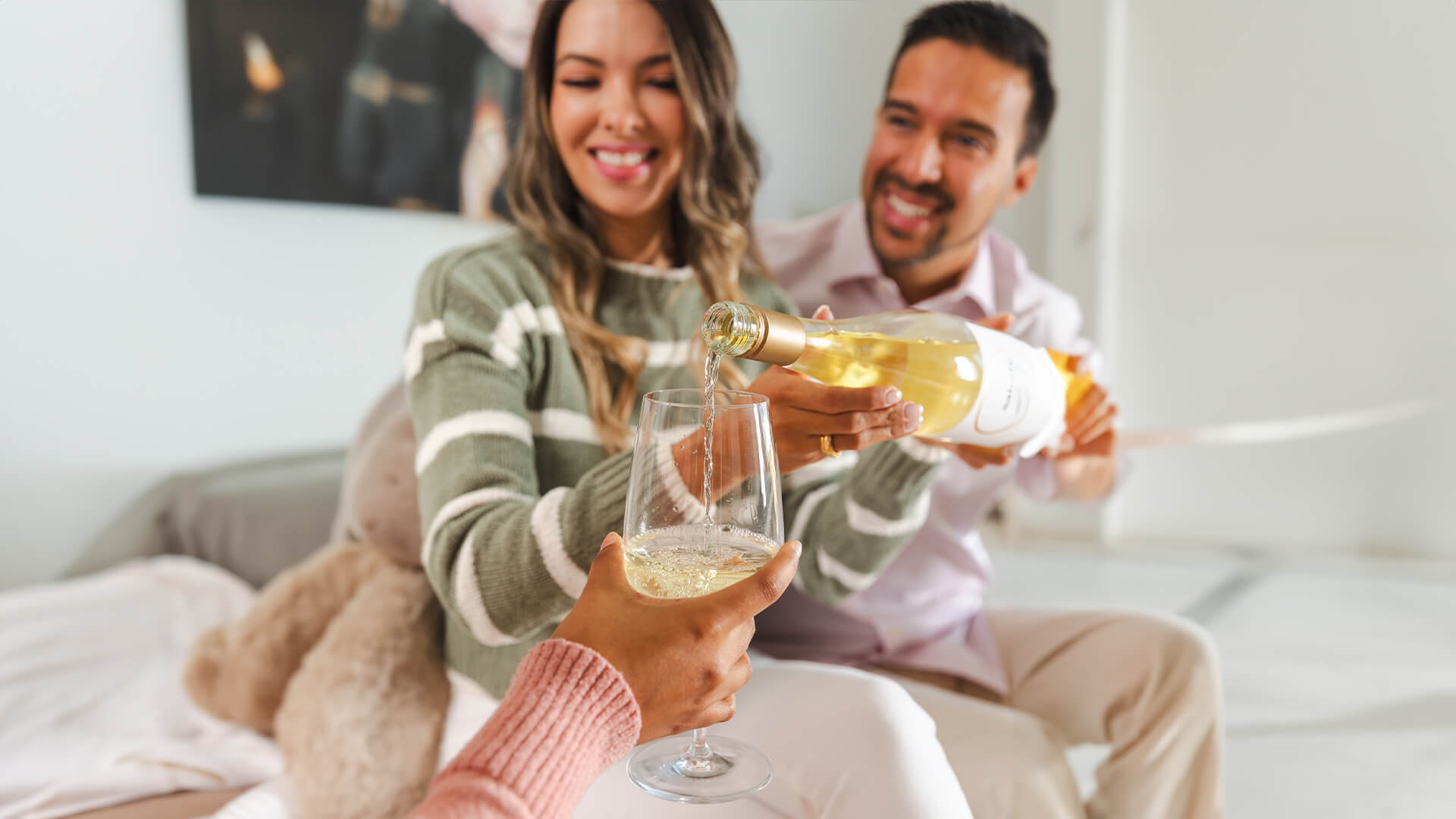 Friends enjoying and appreciating a glass of white wine.